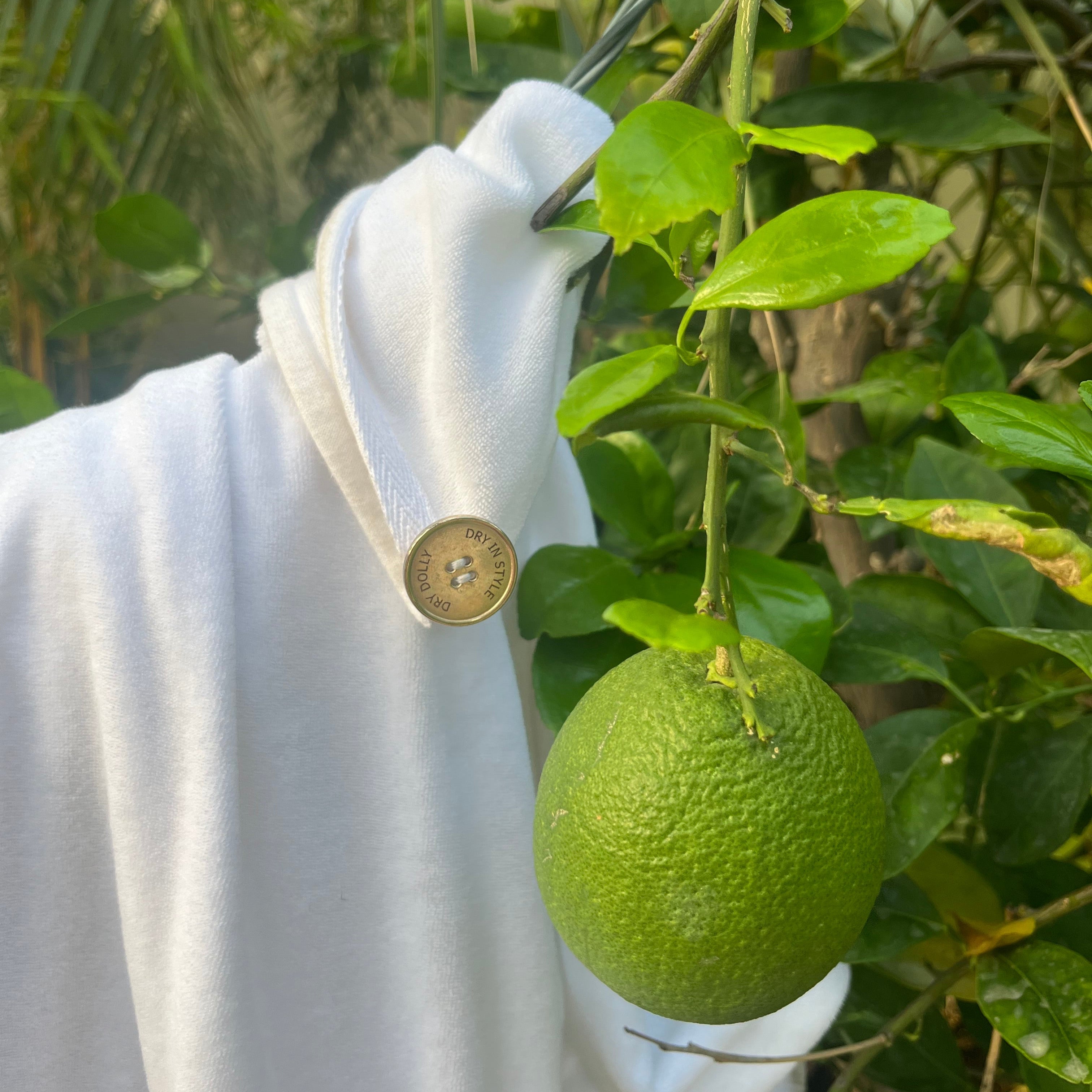 Dry Dolly head towel for Smooth Frizz Free Hair draped over a lime tree, reflecting sustainable luxury and a spa-inspired lifestyle