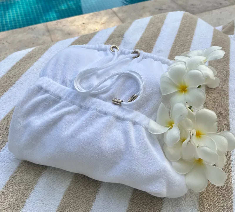 Dry Dolly White Quick Drying Towel Dress Folded on a Sunbed
